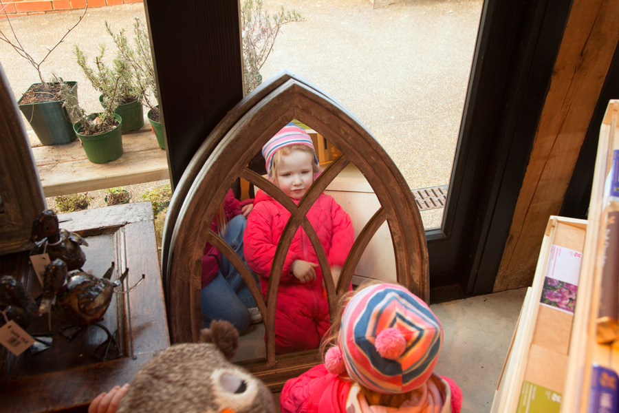 Emily checking out a mirror in the shop