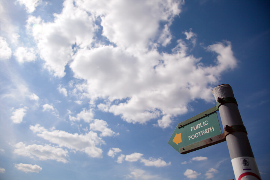 Footpath sign with a backdrop of blue sky